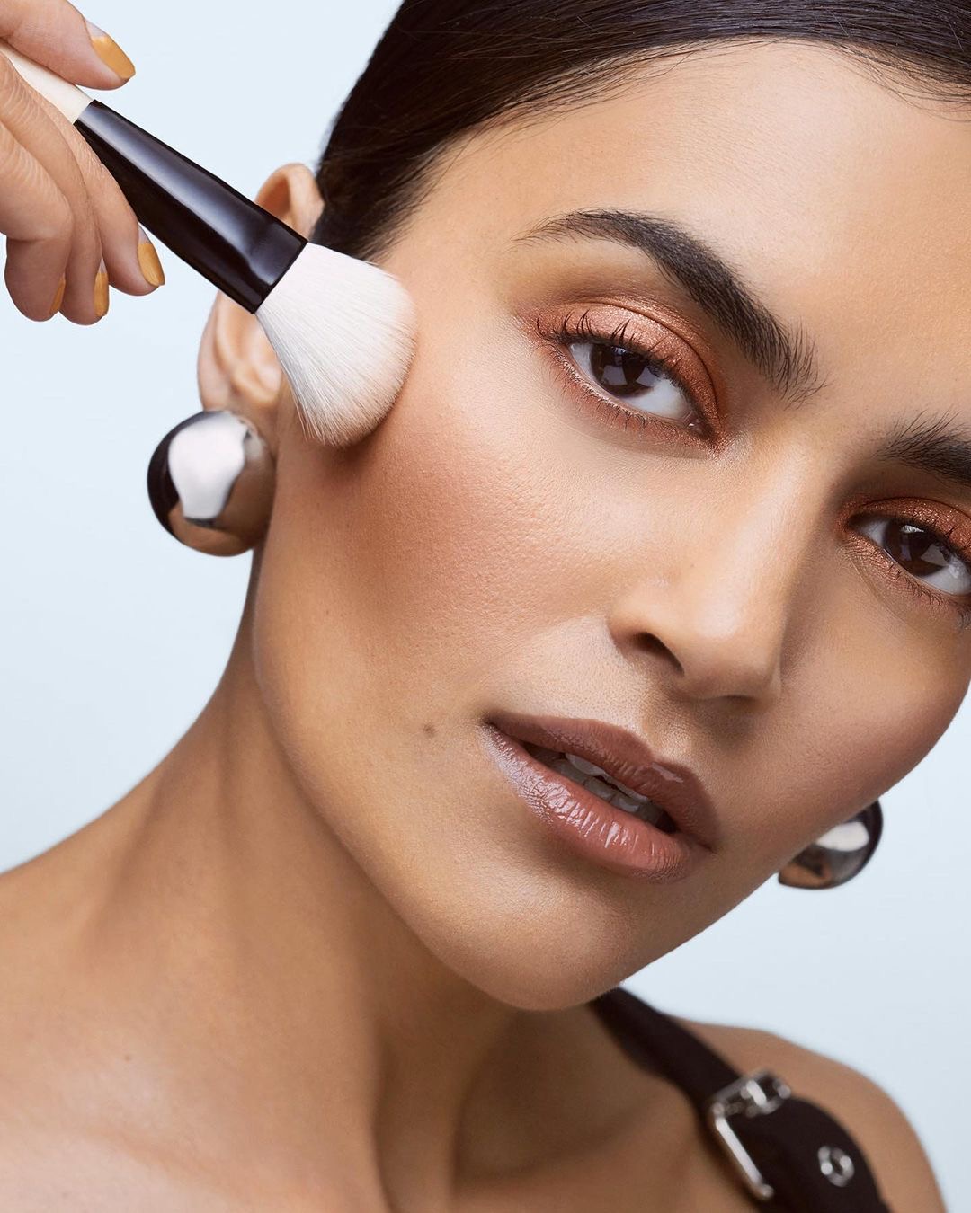 Evening Makeup Tutorial NYC Style: Bold, Confident & City Proof Beauty 5 Woman applying cream contour and blush to sculpt her face.