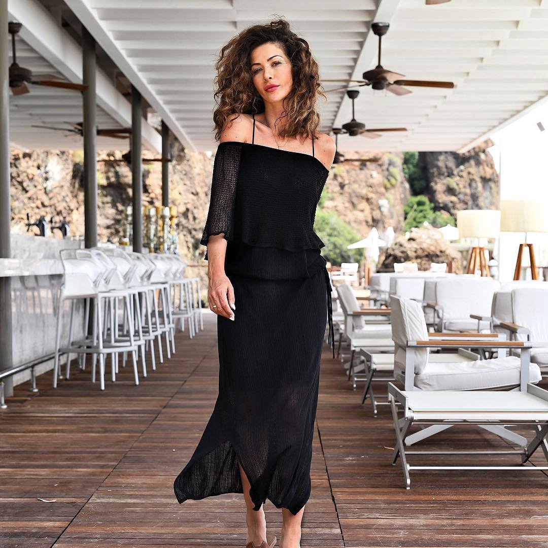 Elegant lady in black dress. fashion studio photo of gorgeous woman with  retro wavy hair style and evening makeup, in long gown with gloves isolated  on black background. Stock Photo | Adobe